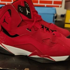Jordan True Flight shoes in the "Gym Red" colorway.